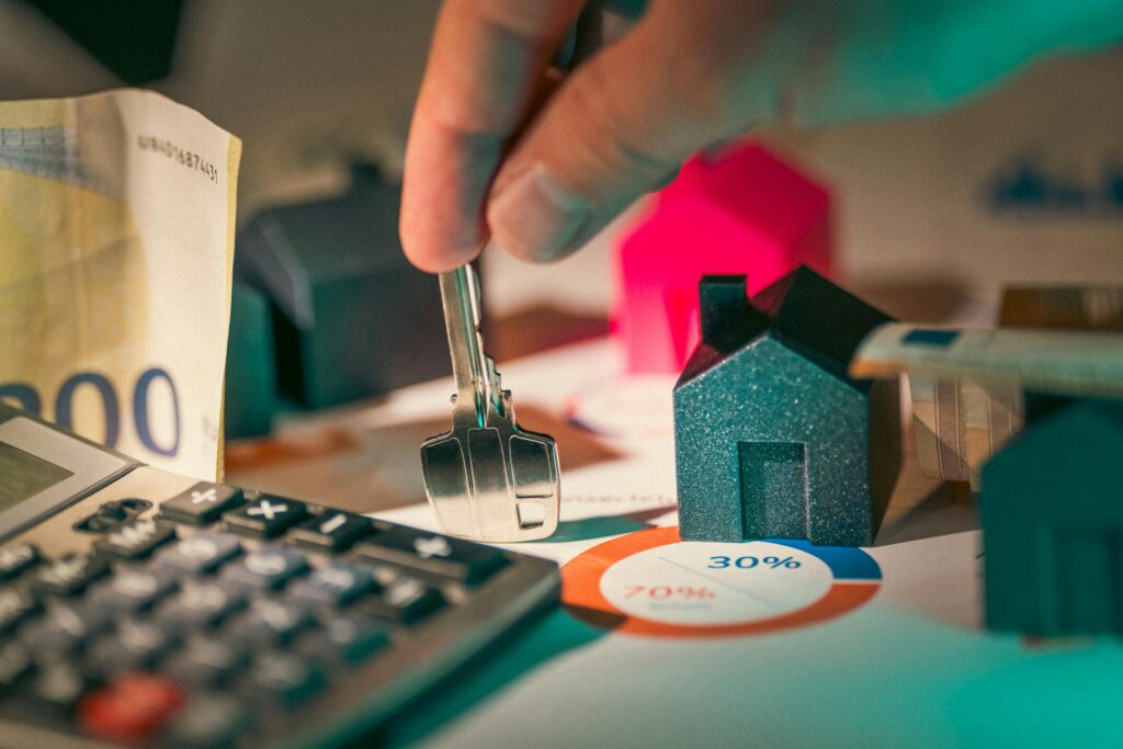 PERSONAL LOANS A close-up of real estate financial planning with keys, calculator, and money.