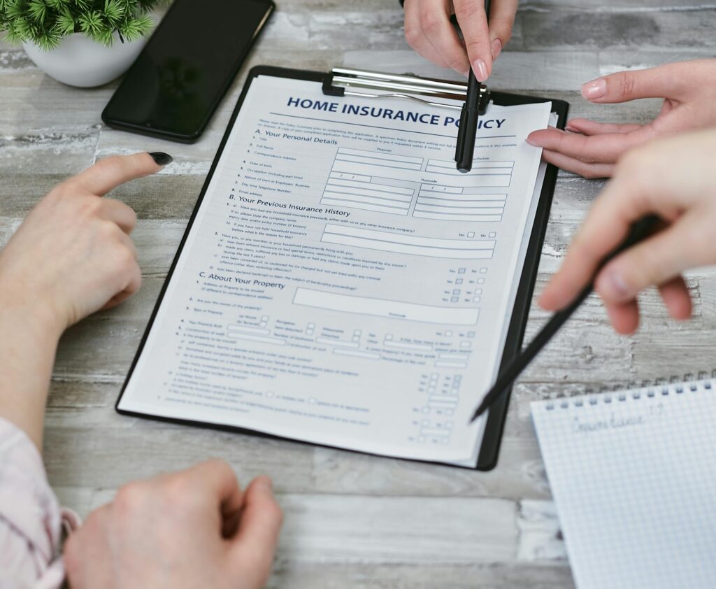 Genral Insurance Three individuals collaborating on a home insurance policy document. Elements include a clipboard, notes, and pointing hands.